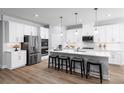 Contemporary kitchen featuring stainless steel appliances, island seating, and stylish pendant lighting at 1560 Covey Rise Ter, Winter Haven, FL 33884