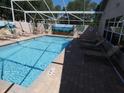 Inviting screened-in swimming pool with lounge chairs and a mural, perfect for relaxation and recreation at 3806 Osprey Pointe Cir, Winter Haven, FL 33884