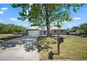 View of the home's exterior with an attached two-car garage, well-maintained lawn, and inviting curb appeal at 201 Lake Gene Dr, Longwood, FL 32779