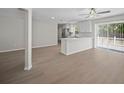 Open-concept living space with wood flooring, seamlessly connecting the living area and a modern kitchen at 201 Lake Gene Dr, Longwood, FL 32779
