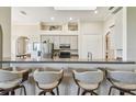 Kitchen features an eat-in bar, pantry, and neutral-colored cabinets, perfect for casual dining and storage at 27223 Nostalgia Dr, Leesburg, FL 34748