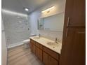 Bathroom featuring double sink vanity, new fixtures, and a glass-enclosed shower with modern tile at 2963 Poplar Ave, Leesburg, FL 34748