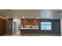 An open-concept living space featuring modern design, wood floors, and large windows at 2963 Poplar Ave, Leesburg, FL 34748