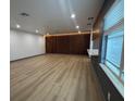 Modern living room featuring sleek wood floors, contemporary accents, and plenty of light at 2963 Poplar Ave, Leesburg, FL 34748