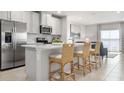Bright kitchen boasts stainless steel appliances, breakfast bar with seating, and seamless access to living area at 1203 Turtle Island Rd, Lady Lake, FL 32159