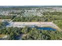 Aerial view of a new home construction site surrounded by lush greenery and a serene pond at 5236 Luisa Ct, St Cloud, FL 34771