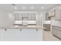 Modern kitchen featuring granite countertops, gray cabinets, and recessed lighting at 5236 Luisa Ct, St Cloud, FL 34771