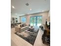 Bright living room with a sliding glass door and a stylish rug for relaxed living at 5236 Luisa Ct, St Cloud, FL 34771