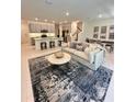 Open-concept living room featuring a modern kitchen and cozy seating area with stylish decor at 5236 Luisa Ct, St Cloud, FL 34771