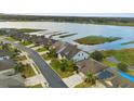 Aerial showcases community waterfront homes with beautiful views of the lake, docks, and picturesque landscaping at 1382 Heritage Landings Dr, Lakeland, FL 33805