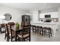 Modern eat-in kitchen boasts stainless appliances, white cabinets, and a quartz countertop island at 420 Harvard Ct, Dundee, FL 33838