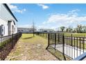 Spacious, fenced backyard with well-maintained grass and a view of neighboring homes at 1126 Desert Candle Dr, Ocoee, FL 34761