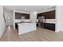 Contemporary kitchen with stainless appliances, an island, and dark wood cabinetry at 1126 Desert Candle Dr, Ocoee, FL 34761