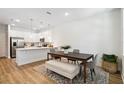 Bright dining area featuring a sleek table and modern furnishings, adjacent to the kitchen for easy entertaining at 3307 Grande Heron Dr, St Cloud, FL 34773