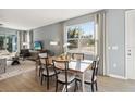 Bright dining room with a wooden table, seating for six, and large windows offering views of the outdoors at 5269 Luisa Ct, St Cloud, FL 34771