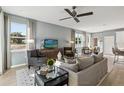 Cozy living room featuring a comfortable sofa, stylish armchairs, and ample natural light from large windows at 5269 Luisa Ct, St Cloud, FL 34771