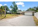 Spacious driveway leads to a two-car garage with attractive stone detail at 2404 Needle Palm Dr, Edgewater, FL 32141