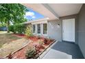 Charming front porch with manicured landscaping and a freshly painted front door at 2404 Needle Palm Dr, Edgewater, FL 32141