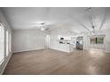 Bright, open-concept living space with modern lighting and new flooring at 2404 Needle Palm Dr, Edgewater, FL 32141