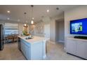 Open kitchen with island, stainless steel sink, tile floor and adjacent dining area at 558 Highfalls Ave, Debary, FL 32713