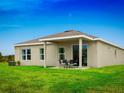 A backyard featuring a covered patio with an outdoor seating area, perfect for relaxing or entertaining guests at 1548 Covey Rise Ter, Winter Haven, FL 33884
