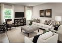 Bright living room features stylish decor, comfortable seating, neutral color palette, and large windows at 2193 Aibonito Cir, Clermont, FL 34711