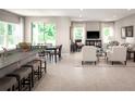 Open concept living and dining area with modern finishes, lots of natural light and a breakfast bar with stool seating at 2193 Aibonito Cir, Clermont, FL 34711