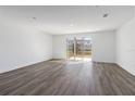 Bright living room with wood floors and sliding glass doors to the backyard at 1096 Desert Candle Dr, Ocoee, FL 34761
