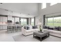 Bright, open living area with large windows and comfortable seating at 136 Venetian Palms Blvd, New Smyrna Beach, FL 32168