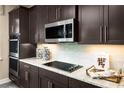 Modern kitchen features stainless steel appliances and granite countertops at 3210 Tiger Palm Way, New Smyrna Beach, FL 32168