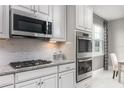Chef's kitchen features stainless steel microwave and double oven, a gas cooktop and ample countertop space at 3250 Tiger Palm Way, New Smyrna Beach, FL 32168