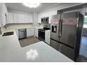 Modern kitchen with stainless steel appliances, white cabinets, and quartz countertops at 2827 Se 2Nd St, Ocala, FL 34471
