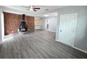 Bright living room with exposed brick fireplace and modern gray floors at 2827 Se 2Nd St, Ocala, FL 34471