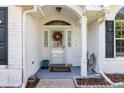 Inviting front porch with decorative wreath and neutral welcome mat at 8596 Sw 108Th Place Rd, Ocala, FL 34481