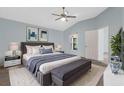Bright bedroom with blue walls, a ceiling fan, plush carpet, and a comfortable king-sized bed at 1424 Figueroa St, The Villages, FL 32162