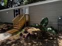 Welcoming home featuring new landscaping, warm gray siding, and a cozy entrance at 3346 Se 131St Pl, Belleview, FL 34420