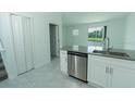 Modern kitchen with stainless steel appliances, gray countertops, and white cabinets at 7433 Stone Creek Trl, Kissimmee, FL 34747