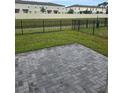 A private backyard offers a peaceful setting with a brick patio and a serene view of the water at 2453 Magnolia Reserve Rd, Ocoee, FL 34761