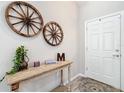 Welcoming entryway featuring rustic decor, a decorative table, and light wood-look flooring at 12396 Sw 64Th Street Rd, Ocala, FL 34481