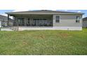 A covered lanai provides a great view of the backyard at 3315 Dzuro Dr, Oxford, FL 34484