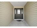 Inviting front entryway featuring a solid wood door with decorative glass accents at 3315 Dzuro Dr, Oxford, FL 34484