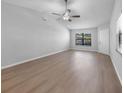 Spacious living room with laminate floors and plenty of natural light, offering a comfortable atmosphere at 4856 Colonnades W Cir, Lakeland, FL 33811