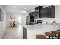 Bright eat-in kitchen features a granite countertop island, stainless steel appliances, and a dining area at 1196 Port Blue Way, Lady Lake, FL 32159