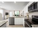 Bright kitchen boasts stainless steel appliances, granite counters, and an open design for easy entertaining at 2303 Incandescent Way, South Daytona, FL 32119