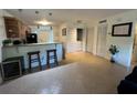 Kitchen and bar with pendant lights and access to laundry room at 3651 N Goldenrod E Rd # 102, Winter Park, FL 32792