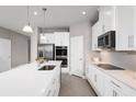 Bright kitchen with white cabinets, stainless steel appliances, and a large center island at 443 Hammock Oaks Blvd, Lady Lake, FL 32159