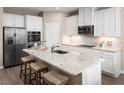 Modern kitchen with stainless steel appliances, granite countertops, and ample cabinet space at 443 Hammock Oaks Blvd, Lady Lake, FL 32159