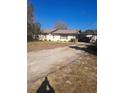 Charming single-story home with a long driveway and carport at 11301 Huggins St, Leesburg, FL 34788