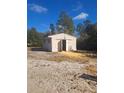 Exterior view of the property's detached storage shed at 11301 Huggins St, Leesburg, FL 34788