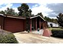 Front exterior view of a well-maintained home with a driveway and landscaped yard at 14545 Sw 34Th Terrace Rd, Ocala, FL 34473